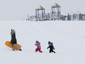Christina Mesavage leads family friend, Una Mayer, center, and her son, Jude, up a sledding hill at the Eastern Promenade while enjoying the snow during a nor'easter Thursday, March 8, 2018, in Portland, Maine. Residents in the Northeast dug out from as much as 2 feet of wet, heavy snow Thursday, while utilities dealt with downed trees and power lines that snarled traffic and left hundreds of thousands of homes and businesses in the dark after two strong nor'easters - all with the possibility of another storm headed to the area.