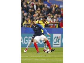 France's Olivier Giroud, front, and Colombia's Yerry Mina challenge for the ball during a friendly soccer match between France and Colombia in Saint-Denis, outside Paris, Friday March 23, 2018.