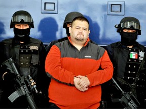 Eduardo Teodoro Garcia Simental, a.k.a "El Teo," one of Mexico's most-wanted drug lords with possible connections to the Arellano Felix brothers or Tijuana cartels, is seen guarded by police officers in Mexico City on January 12, 2010.