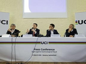 UCI President David Lappartient, 2nd left, sitting next to Gabriele Fioni, left, Deputy Director of CEA Tech, Jean-Christophe Peraud, 2nd right, Manager of Equipment and the Fight against technological fraud of UCI, and Bob Stapleton, right, UCI Management Committee member and President of the Equipment and Fight against technological fraud Commission, informs to the media  during a press conference, in Geneva, Switzerland, Wednesday, March 21, 2018.