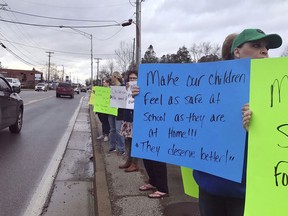 This Feb. 21, 2018 photo made available by Lex18 News, shows a group protesting school safety in Laurel County, Ky. In the wake of a mass shooting at a Florida high school, parents and educators are mobilizing to demand more school safety measures, including armed officers, security cameras, door locks, etc.