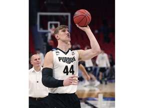 Purdue center Isaac Haas shoots during warmups before a second round game against Butler in the NCAA college basketball tournament, Sunday, March 18, 2018, in Detroit. A day after Isaac Haas' season was declared over, there's now a bit of mystery surrounding the status of Purdue's star center. That could be encouraging news for the second-seeded Boilermakers, who announced Friday that Haas would miss the rest of the NCAA Tournament with a broken elbow. On Saturday, a CBS reporter tweeted that Haas had practiced with the team, although coach Matt Painter tried to keep expectations low for a possible return.