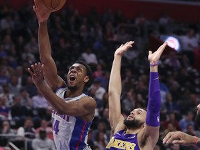 Detroit Pistons guard Ish Smith (14) shoots as Los Angeles Lakers guard Tyler Ennis (10) defends during the first half of an NBA basketball game, Monday, March 26, 2018, in Detroit.