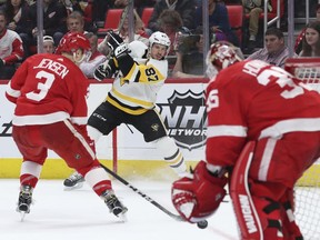 Pittsburgh Penguins center Sidney Crosby (87) shoots the puck toward Detroit Red Wings goaltender Jimmy Howard (35) during the first period of an NHL hockey game Tuesday, March 27, 2018, in Detroit.