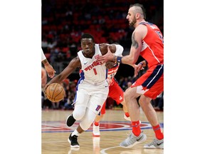 Detroit Pistons guard Reggie Jackson (1) drives to the basket against Washington Wizards center Marcin Gortat during the first half of an NBA basketball game Thursday, March 29, 2018, in Detroit.