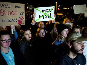 FILE - In this Jan. 26, 2018 file photo, dozens of Michigan State University students take to the streets as they protest in support of sexual assault survivors throughout campus, in East Lansing, Mich. William Strampel, who until December was dean of the College of Osteopathic Medicine at the university and oversaw a clinic that employed disgraced former sports doctor Larry Nassar, has been charged with using his office to sexually proposition female medical students and compile nude "selfies" of students on his work computer.