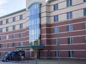 A crime scene response vehicle is parked outside Central Michigan University's Campbell Hall after a fatal shooting, Friday, March 2, 2018, in Mount Pleasant, Mich. More than 100 police officers, some heavily armed in camouflage uniforms, searched neighborhoods near the school Friday for a 19-year-old student suspected of killing his parents at the dormitory and then running from campus.