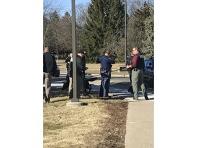 Authorities gather on the campus of Central Michigan University during a search for a suspect, in Mount Pleasant, Mich., Friday, March 2, 2018. School officials say police are responding to a report of shots fired at a residence hall at the university.