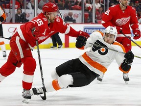 Detroit Red Wings defenseman Niklas Kronwall (55) checks Philadelphia Flyers center Valtteri Filppula (51) during the first period of an NHL hockey game Tuesday, March 20, 2018, in Detroit.