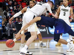 Cal State Fullerton forward Jackson Rowe (34) loses the ball as Purdue forward Matt Haarms (32) defends during the first half of an NCAA men's college basketball tournament first-round game in Detroit, Friday, March 16, 2018.