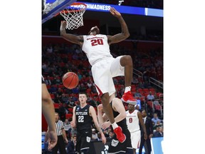 Arkansas forward Darious Hall (20) dunks against Butler during the first half of an NCAA men's college basketball tournament first-round game in Detroit, Friday, March 16, 2018.