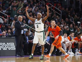 Michigan State guard Cassius Winston (5) reacts to hitting a basket against Bucknell during the first half of an NCAA men's college basketball tournament first-round game in Detroit, Friday, March 16, 2018.