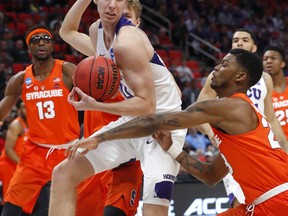 TCU forward Vladimir Brodziansky (10) pulls down a rebound from Syracuse guard Frank Howard (23) during the first half of an NCAA men's college basketball tournament first-round game in Detroit, Friday, March 16, 2018.