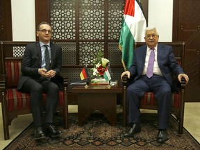 German Foreign Minister Heiko Maas, left, meets with the Palestinian President Mahmoud Abbas, in the West Bank city of Ramallah, Monday, March 26, 2018. (AP Photo/Majdi Mohammed)