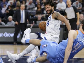 Minnesota Timberwolves Derrick Rose (25) is called for a charge on Los Angeles Clippers guard Milos Teodosic (4) in the first quarter of an NBA basketball game Tuesday, March 20, 2018, in Minneapolis.