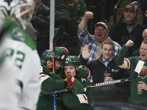 Minnesota Wild right wing Mikael Granlund is congratulated by Mikko Koivu (9) after scoring on Dallas Stars goalie Kari Lehtonen (32) during the first period of an NHL hockey game Thursday, March 29, 2018, in St. Paul, Minn.