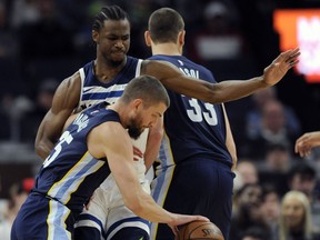 Minnesota Timberwolves' Andrew Wiggins (22) guards against Memphis Grizzlies' Chandler Parsons (25) during the second quarter of an NBA basketball game on Monday, March 26, 2018, in Minneapolis.