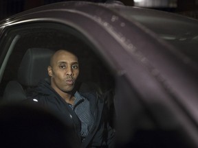 Former Minneapolis Police Officer Mohamed Noor sits in the pickup truck of his attorney, Thomas Plunkett, after posting bond and leaving the Hennepin County Public Safety Facility in Minneapolis on Wednesday, March 21, 2018. The police officer who was with Noor, charged with murder and manslaughter in the death of an unarmed Australian woman, said both men "got spooked" when she approached their SUV, and that the partner feared for his life. But prosecutors say Noor acted recklessly and was not justified in using deadly force when he shot Justine Ruszczyk Damond last July after she called to report a possible sexual assault behind her home.