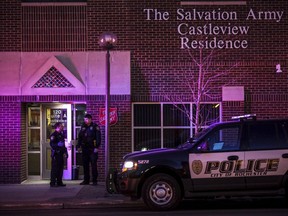 Emergency personnel respond to the scene of a fatal stabbing Saturday, March 17, 2018, at the Salvation Army Castleview Residence in downtown Rochester, Minn. Police have arrested a man in the multiple fatal stabbings at a Salvation Army apartment building in Minnesota.