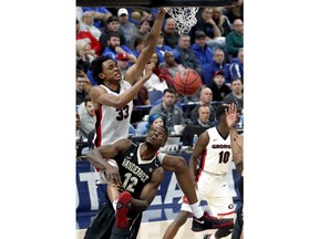 Georgia's Nicolas Claxton (33) dunks the ball over Vanderbilt's Djery Baptiste (12) during the first half in an NCAA college basketball game at the Southeastern Conference tournament Wednesday, March 7, 2018, in St. Louis.