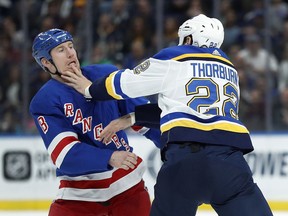 New York Rangers' Cody McLeod, left, and St. Louis Blues' Chris Thorburn fight during the first period of an NHL hockey game Saturday, March 17, 2018, in St. Louis.