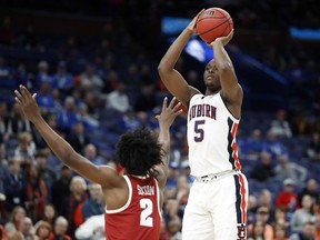 Auburn's Mustapha Heron (5) shoots over Alabama's Collin Sexton (2) during the first half in an NCAA college basketball quarterfinals game at the Southeastern Conference tournament Friday, March 9, 2018, in St. Louis.