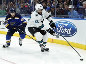 San Jose Sharks' Joel Ward (42) chases after a loose puck along the boards as St. Louis Blues' Ivan Barbashev, of Russia, defends during the first period of an NHL hockey game Tuesday, March 27, 2018, in St. Louis.