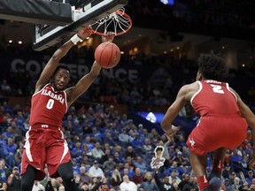 Alabama's Donta Hall, left, dunks as teammate Collin Sexton watches during the second half in an NCAA college basketball quarterfinal game against Auburn at the Southeastern Conference tournament Friday, March 9, 2018, in St. Louis. Alabama won 81-63.