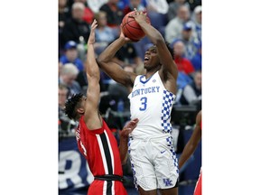 Kentucky's Hamidou Diallo, right, shoots over Georgia's Juwan Parker during the first half in an NCAA college basketball quarterfinal game at the Southeastern Conference tournament Friday, March 9, 2018, in St. Louis.