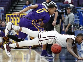 Mississippi State's Eli Wright, bottom, is unable to keep a ball in bounds as LSU's Brandon Sampson (0) watches during the first half in an NCAA college basketball game at the Southeastern Conference tournament Thursday, March 8, 2018, in St. Louis.