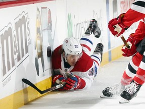 Montreal Canadiens forward Nikita Scherbak falls into the boards against the New Jersey Devils on March 6.