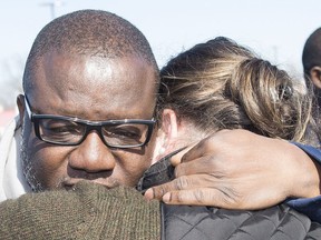 Kouadio Frederic Kouakou, father of missing boy Ariel Jeffrey Kouakou is hugged by a supporter after speaking to the media in Montreal, Tuesday, March 20, 2018.