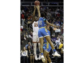 Texas guard Ariel Atkins (23) shoots over UCLA forward Monique Billings (25) during the first half of a women's NCAA college basketball tournament regional semifinal game, Friday, March 23, 2018, in Kansas City, Mo.