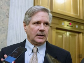 FILE - In this Feb. 3, 2016, file photo, U.S. Sen. John Hoeven, R-N.D. speaks to reporters on Capitol Hill in Washington. Congressional committees and farm groups have crafted language to fix a provision in the federal tax overhaul that gave an unintended tax advantage to farmers who sell their crops to cooperatives instead of other buyers. Hoeven and other senators are trying to get it included in a massive spending bill that needs to pass by March 23.