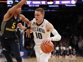 Villanova guard Donte DiVincenzo (10) drives around Marquette guard Greg Elliott (5) during the first half of an NCAA college basketball game in the quarterfinals of the Big East men's tournament in New York, Thursday, March 8, 2018.