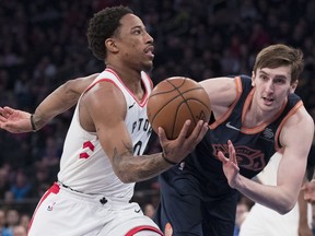 Toronto Raptors guard DeMar DeRozan, left,  drives to the basket past New York Knicks forward Luke Kornet, right, during the first half of an NBA basketball game, Sunday, March 11, 2018, at Madison Square Garden in New York.