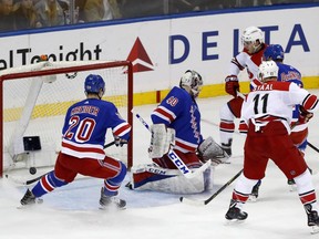 New York Rangers left wing Chris Kreider (20) watches as Carolina Hurricanes left wing Teuvo Teravainen, upper right, of Finland, scores while Rangers goaltender Alexandar Georgiev (40), of Bulgaria, looks behind during the first period of an NHL hockey game in New York, Monday, March 12, 2018.