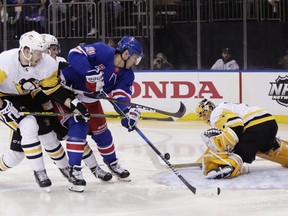 Pittsburgh Penguins goaltender Casey DeSmith (1) stops a shot on goal by New York Rangers' Chris Kreider (20) during the second period of an NHL hockey game Wednesday, March 14, 2018, in New York.
