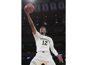 Michigan guard Muhammad-Ali Abdur-Rahkman goes to the basket during the first half of an NCAA college basketball game against Iowa in the second round of the Big Ten conference tournament, Thursday, March 1, 2018, at Madison Square Garden in New York.