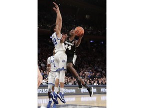Providence's Isaiah Jackson (44) drives past Xavier's Kaiser Gates (22) during overtime of an NCAA college basketball game in the Big East men's tournament semifinals Friday, March 9, 2018, in New York.