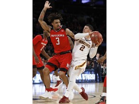 Rutgers guard Corey Sanders (3) defends against Minnesota guard Nate Mason (2) during the first half of an NCAA college basketball game in the first round of the Big Ten men's tournament, Wednesday, Feb. 28, 2018, in New York.