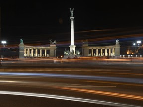 A view of the Millennium Monument, a landmark of the Hungarian capital with its illumination switched on prior to the Earth Hour event, in Budapest, Hungary, Saturday, March 24, 2018. Earth Hour is a world-wide environmental campaign that is observed on the last Saturday of March every year, and is a global call to turn off the lights for 60 minutes to raise awareness of the danger of global climatic change.