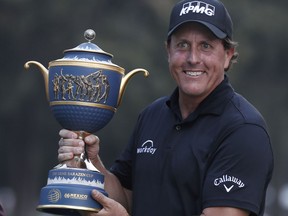 Phil Mickelson, of the U.S., poses with his Mexico Championship trophy at the Chapultepec Golf Club in Mexico City, Sunday, March 4, 2018.