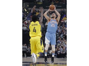 Los Angeles Clippers guard Austin Rivers (25) shoots over Indiana Pacers guard Victor Oladipo (4) during the first half of an NBA basketball game in Indianapolis, Friday, March 23, 2018.