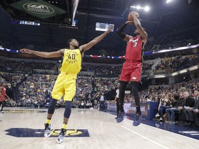 Miami Heat guard Dwyane Wade (3) shoots over Indiana Pacers guard Glenn Robinson III (40) during the first half of an NBA basketball game in Indianapolis, Sunday, March 25, 2018.
