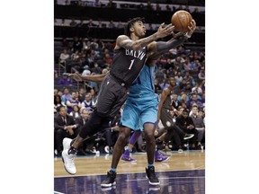 Brooklyn Nets' D'Angelo Russell (1) drives past Charlotte Hornets' Treveon Graham (21) during the first half of an NBA basketball game in Charlotte, N.C., Thursday, March 8, 2018.