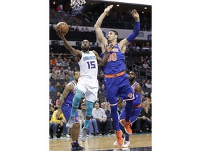 Charlotte Hornets' Kemba Walker (15) drives past New York Knicks' Enes Kanter (00) during the first half of an NBA basketball game in Charlotte, N.C., Monday, March 26, 2018.