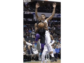 Charlotte Hornets' Kemba Walker (15) droves past Memphis Grizzlies' Ivan Rabb (10) during the first half of an NBA basketball game in Charlotte, N.C., Thursday, March 22, 2018.