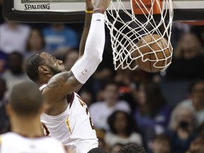 Cleveland Cavaliers' LeBron James dunks against the Charlotte Hornets during the first half of an NBA basketball game in Charlotte, N.C., Wednesday, March 28, 2018.