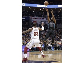 Charlotte Hornets' Kemba Walker (15) shoots over Cleveland Cavaliers' LeBron James (23) during the first half of an NBA basketball game in Charlotte, N.C., Wednesday, March 28, 2018.